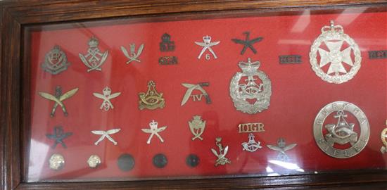 A framed collection of military badges